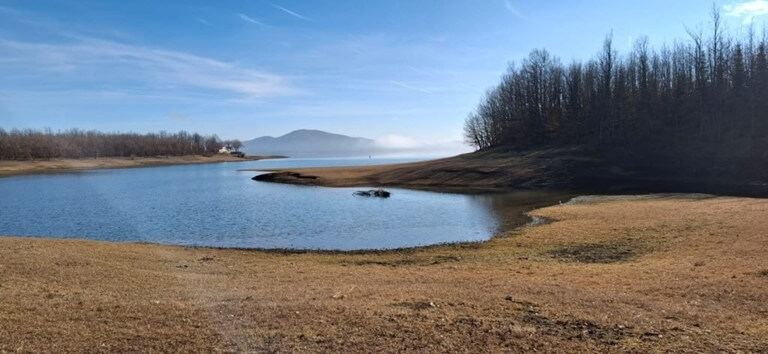 Serene winter view of Lake Plastira during our private tour. Breathtaking winter landscape of the calm and mirrored waters of Lake Plastira Greece.